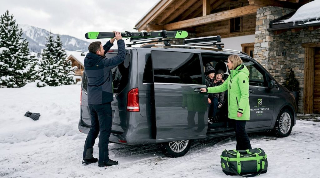 Family loading into van outside snowy chalet